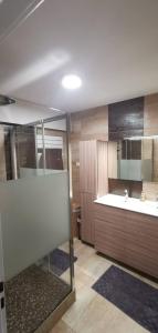 a bathroom with a tub and a sink and a mirror at Chambre privé avec loggia chez l'habitant in Champigneulles