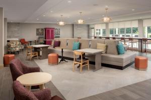 a lobby with a couch and tables and chairs at Home2 Suites By Hilton Owings Mills, Md in Owings Mills