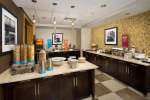 a large kitchen with a counter in a restaurant at Hampton Inn & Suites Baltimore North/Timonium, MD in Timonium