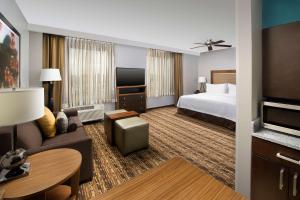 a hotel room with a bed and a living room at Homewood Suites by Hilton Washington DC NoMa Union Station in Washington