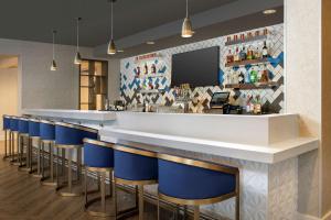 a bar with a row of blue stools at Tru By Hilton Denver Airport Tower Road in Denver