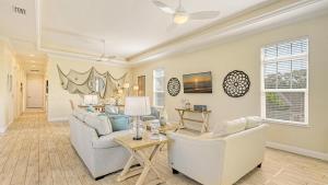 a living room with a couch and chairs and a table at Casa Antilles - 1036L in Siesta Key