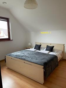 a bedroom with a large bed in a room at MB House Sarbinowo in Sarbinowo