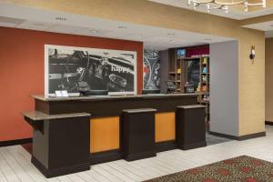 a lobby with a bar with a picture on the wall at Hampton Inn & Suites Lakeland-South Polk Parkway in Lakeland