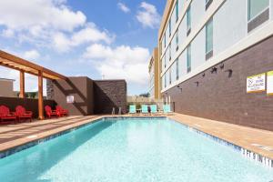 a swimming pool in front of a building at Home2 Suites By Hilton Clermont in Clermont