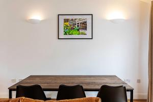 a dining room with a table and chairs at Light and airy upside down house in Boho Hackney in London