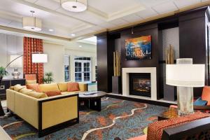 a living room with a couch and a fireplace at Homewood Suites by Hilton Orlando Airport in Orlando