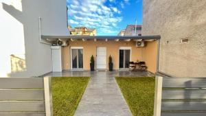 a house with a fence and a patio at Ria's GardenView apartment in Ioannina