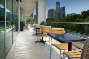 a balcony with tables and chairs and a view of the city at Homewood Suites by Hilton Miami Downtown/Brickell in Miami