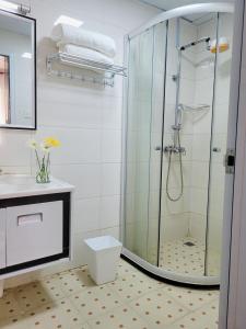 a bathroom with a shower with a toilet and a sink at Stunning and serene homes in Nairobi