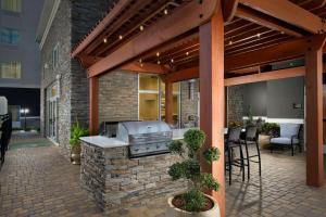 an outdoor kitchen with a grill on a patio at Homewood Suites by Hilton Metairie New Orleans in Metairie