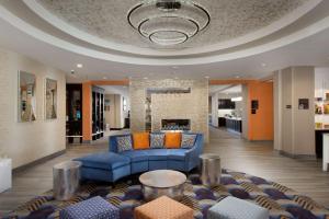 a living room with a blue couch and a fireplace at Homewood Suites by Hilton Metairie New Orleans in Metairie