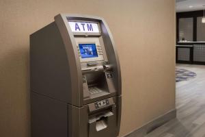 an atm machine in a room with a wall at Homewood Suites by Hilton Metairie New Orleans in Metairie