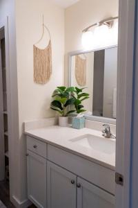 a bathroom with a sink and a mirror at Madrona's Cottage- Fully fenced and pet friendly in Charleston