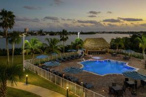 a resort with a pool and chairs and a body of water at Hampton Inn Marathon - Florida Keys in Marathon