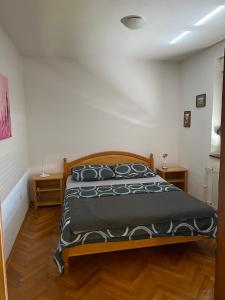 a bedroom with a bed with a black comforter at Apartman Lavanda in Drvar