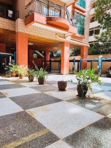 a courtyard with potted plants in front of a building at Stunning and serene homes in Nairobi