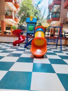 a playground with a slide on a checkered floor at Stunning and serene homes in Nairobi