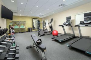a gym with several treadmills and exercise bikes at Home2 Suites By Hilton Phoenix Airport South in Phoenix