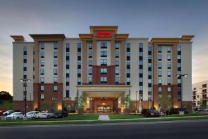 a hotel with a sign on the front of it at Hampton Inn & Suites Falls Church in Falls Church