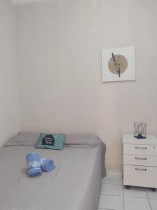 um quarto com uma cama com chinelos azuis em Studio 2 próximo ao Centro em Palmas