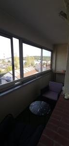 a living room with a couch and a window at Chambre privé avec loggia chez l'habitant in Champigneulles