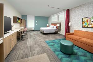a hotel room with a bed and a couch at Home2 Suites By Hilton Edison in Edison +26 photos