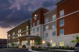 a hotel building with a sign on the front of it at Homewood Suites San Antonio Airport in San Antonio