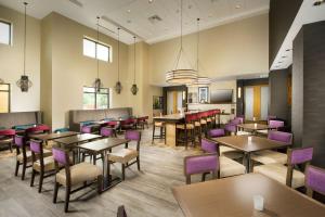 a dining room with tables and purple chairs at Hampton Inn & Suites San Antonio Northwest/Medical Center in San Antonio