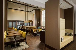 a restaurant with tables and chairs and a dining room at Hampton Inn & Suites Syracuse/Carrier Circle in East Syracuse