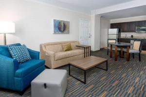 a living room with a couch and a table at Hampton Inn & Suites Buffalo/Downtown in Buffalo