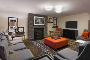 a living room with a couch and a fireplace at Hampton Inn Danbury in Danbury