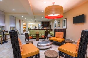 a lobby with chairs and tables and a bar at Hilton Garden Inn Wayne in Wayne