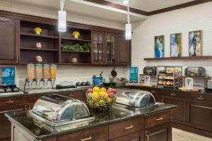 a large kitchen with a counter with a bowl of fruit at Homewood Suites by Hilton Holyoke-Springfield/North in Holyoke