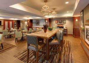 a dining room with a large wooden table and chairs at Hampton Inn South Plainfield-Piscataway in South Plainfield