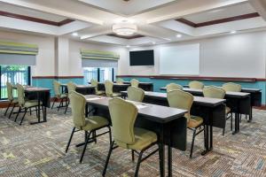 a conference room with tables and chairs and a whiteboard at Hampton Inn South Plainfield-Piscataway in South Plainfield