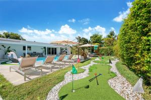 a backyard with chairs and a golf course in a yard at Miami Paradise in Miami