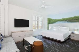 a white bedroom with a bed and a tv at Homewood Suites by Hilton Sarasota-Lakewood Ranch in Sarasota