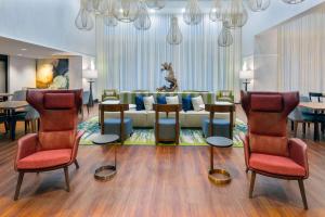 a living room with a couch and tables and chairs at Hampton Inn and Suites Sarasota/Lakewood Ranch in Sarasota