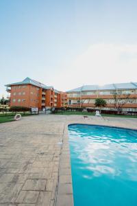 a swimming pool in front of a building at Executive Three Bedroom Condo on the Greens in Trincity 
