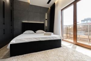 a bedroom with a large bed and a large window at Istanbul Apartment 01 in Tashkent
