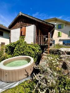 a large bath tub in front of a house at La Carlina - Loft entre lac et montagnes in Orcier