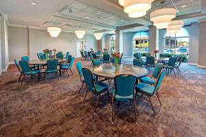 a conference room with tables and chairs and windows at Hilton Garden Inn Nashville Brentwood in Brentwood