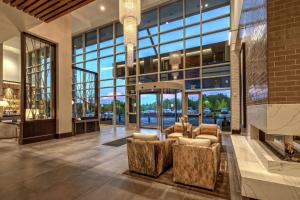 a lobby of a building with chairs and windows at Hilton Franklin Cool Springs in Franklin