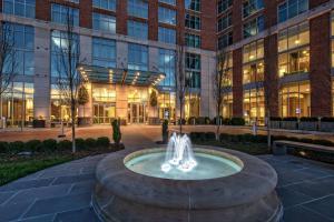 a fountain in a courtyard in front of a building at Hilton Nashville Green Hills in Nashville