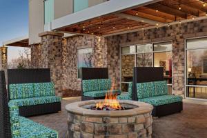 a patio with two chairs and a fire pit at Home2 Suites By Hilton Colorado Springs South, Co in Colorado Springs