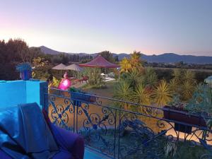 a room with a balcony with a view of a garden at Orange Ville in Villamassargia