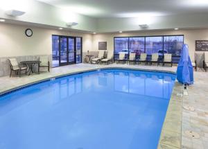 a pool in a hotel with chairs and tables at Hampton Inn & Suites Colorado Springs/I-25 South in Colorado Springs