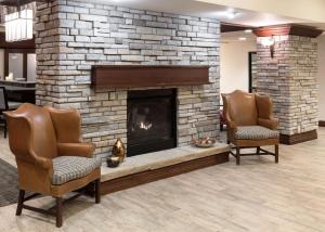 a lobby with two chairs and a fireplace at Hampton Inn & Suites Colorado Springs/I-25 South in Colorado Springs
