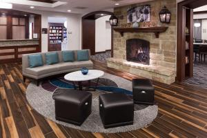 a living room with a couch and a fireplace at Homewood Suites Denton in Denton